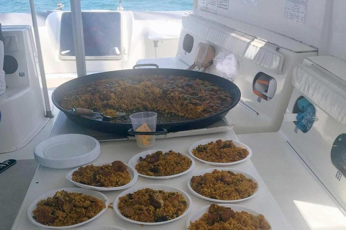 a large pot of food on a stove with bowls of food