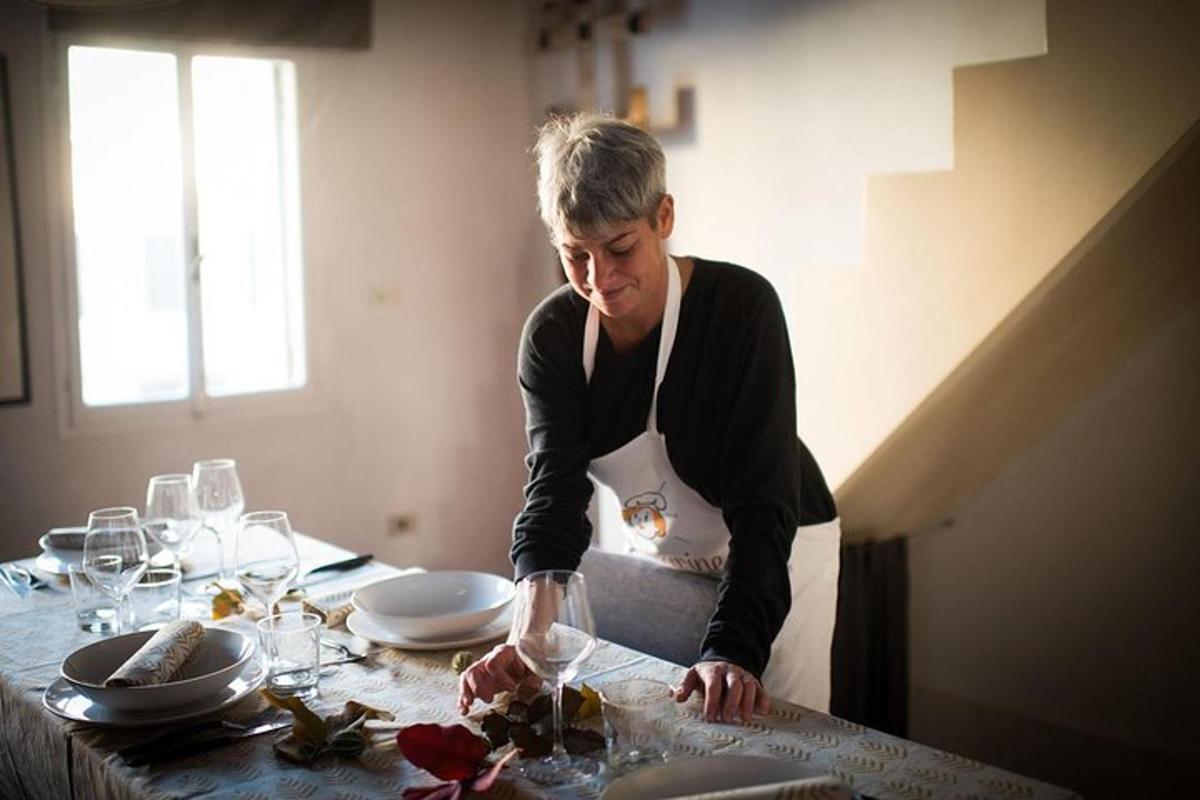 a woman in an apron standing at a table