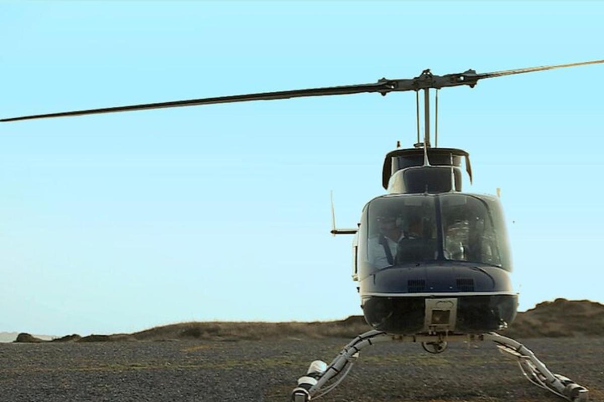 a helicopter is parked in a field
