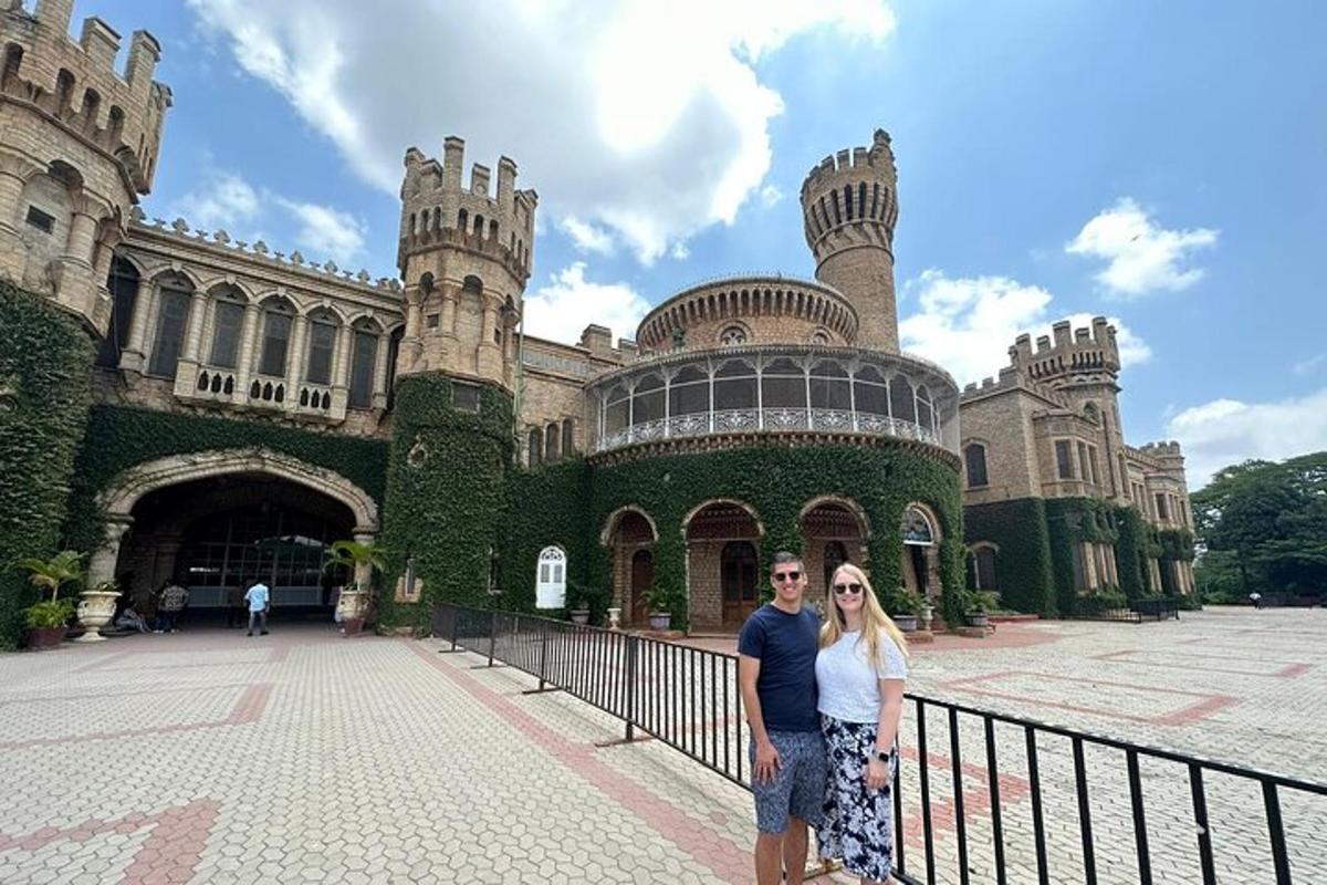 a man and woman standing in front of a castle