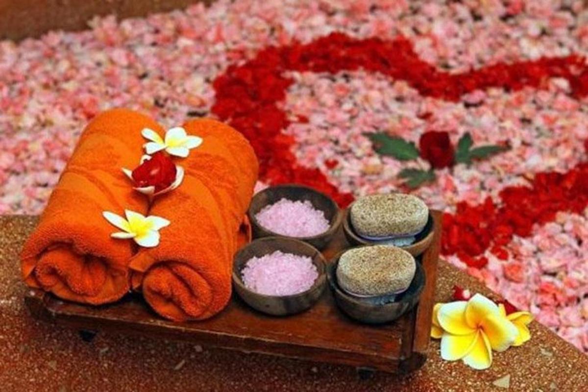 a tray with towels and some spices and some flowers