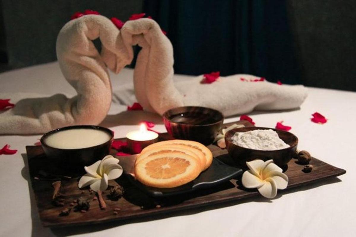 a tray of food with rice and two flamingos and candles