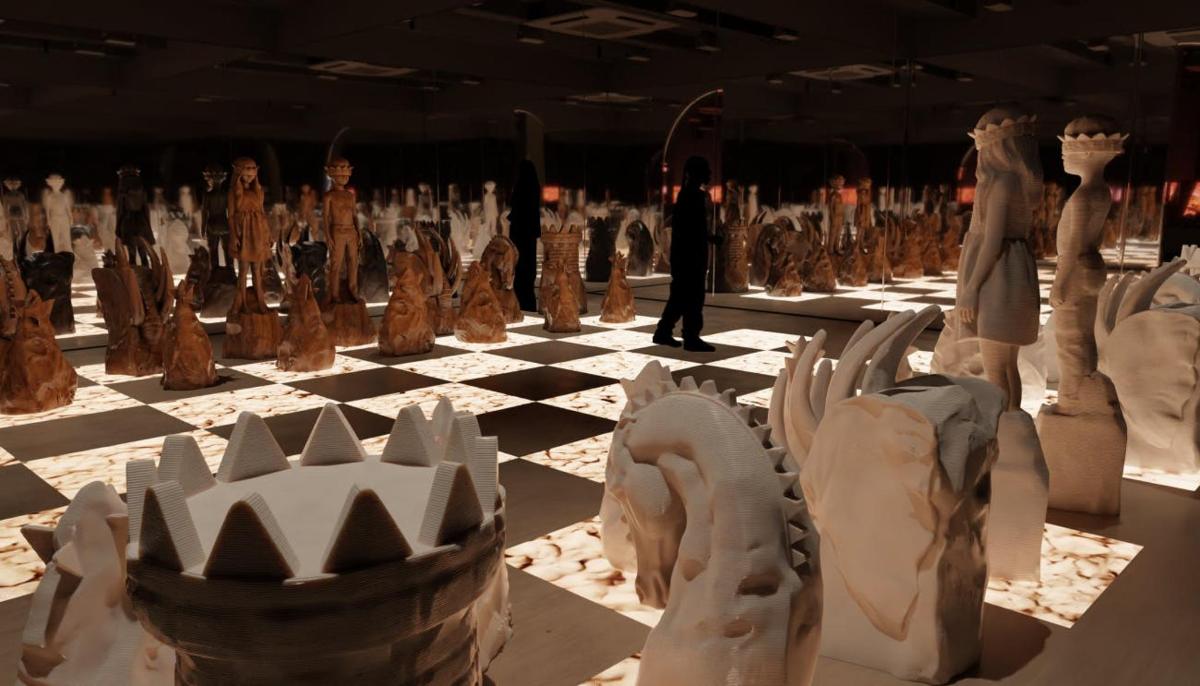 a man standing in a room filled with sculptures
