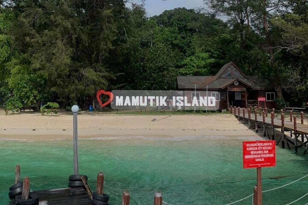 a sign that reads mankitz island on a beach