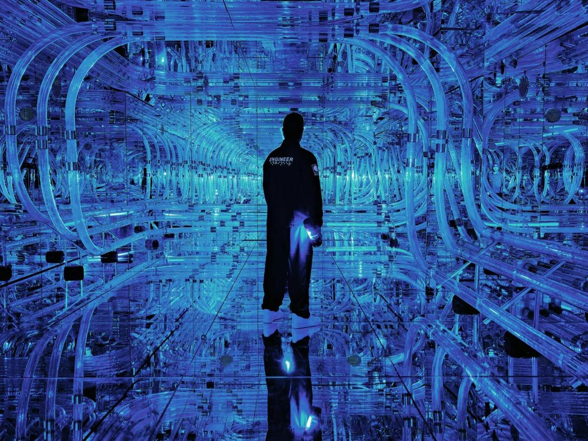 a man is standing in a tunnel of data