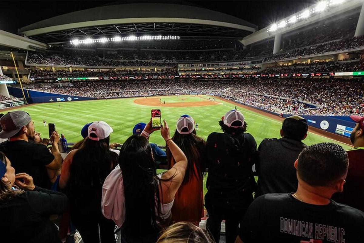 a crowd of people taking pictures of a baseball game