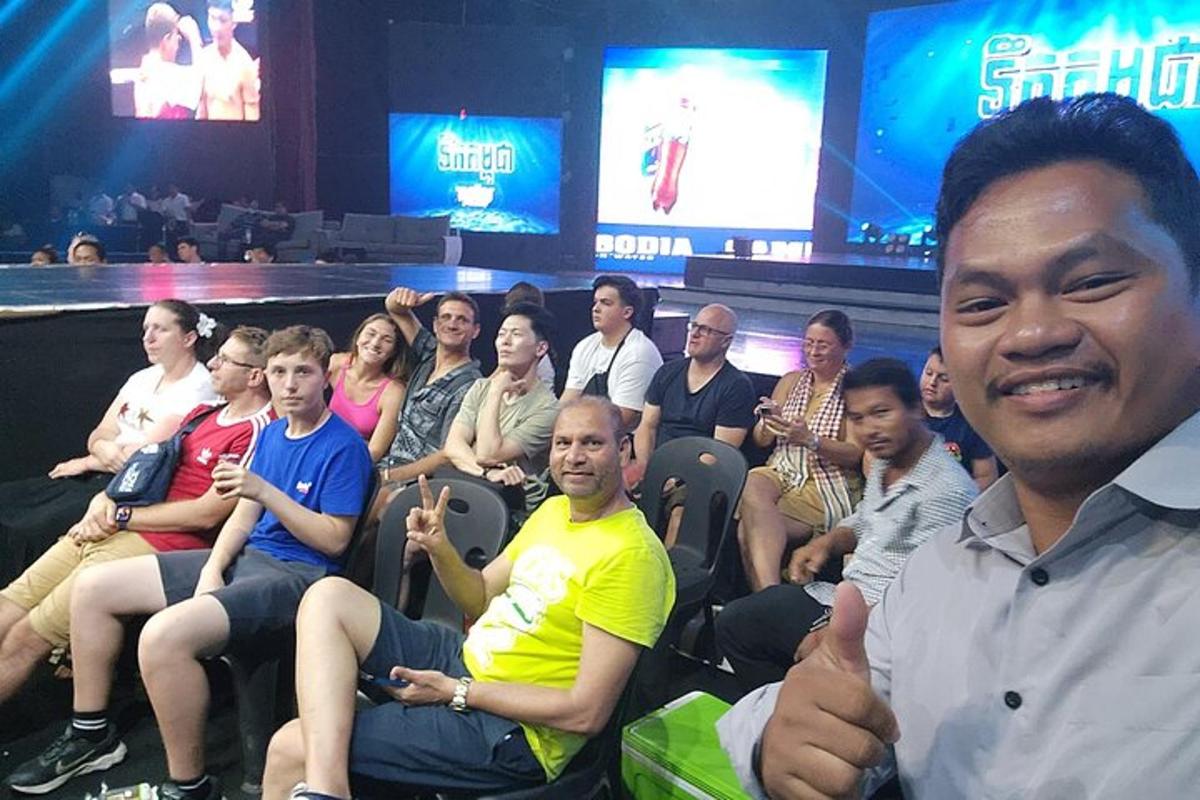 a group of people sitting in a crowd in a theater