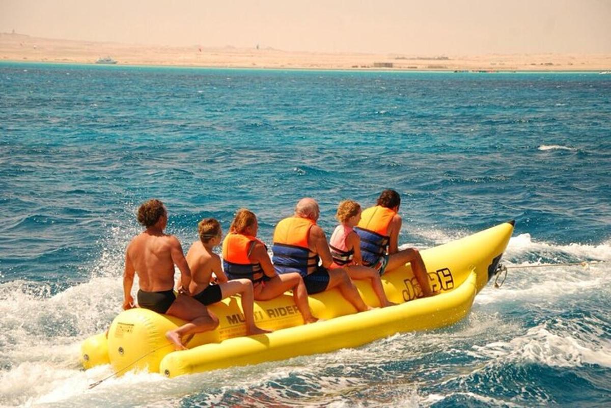 a group of people riding on a yellow raft in the water