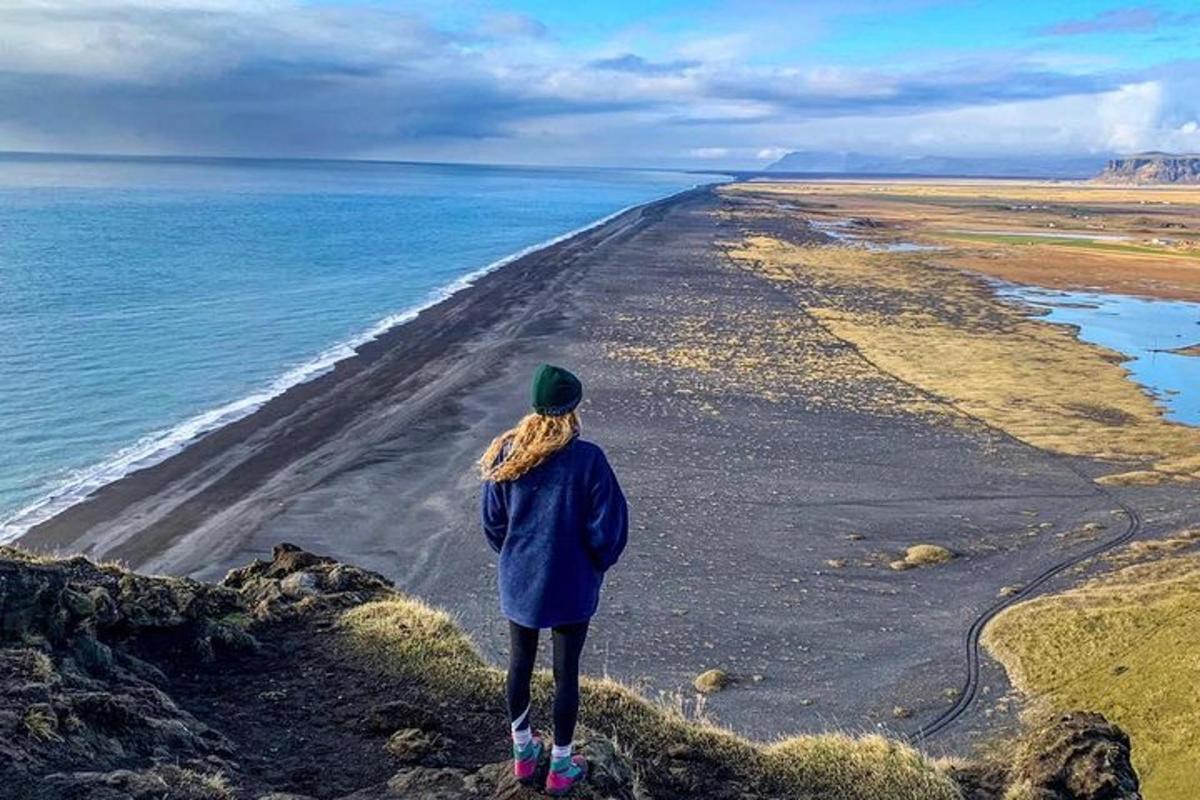 a person standing on a cliff looking at the ocean