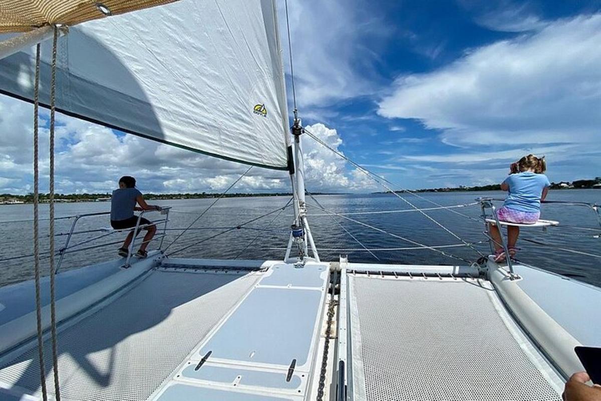 a man and a woman on a sailboat on the water