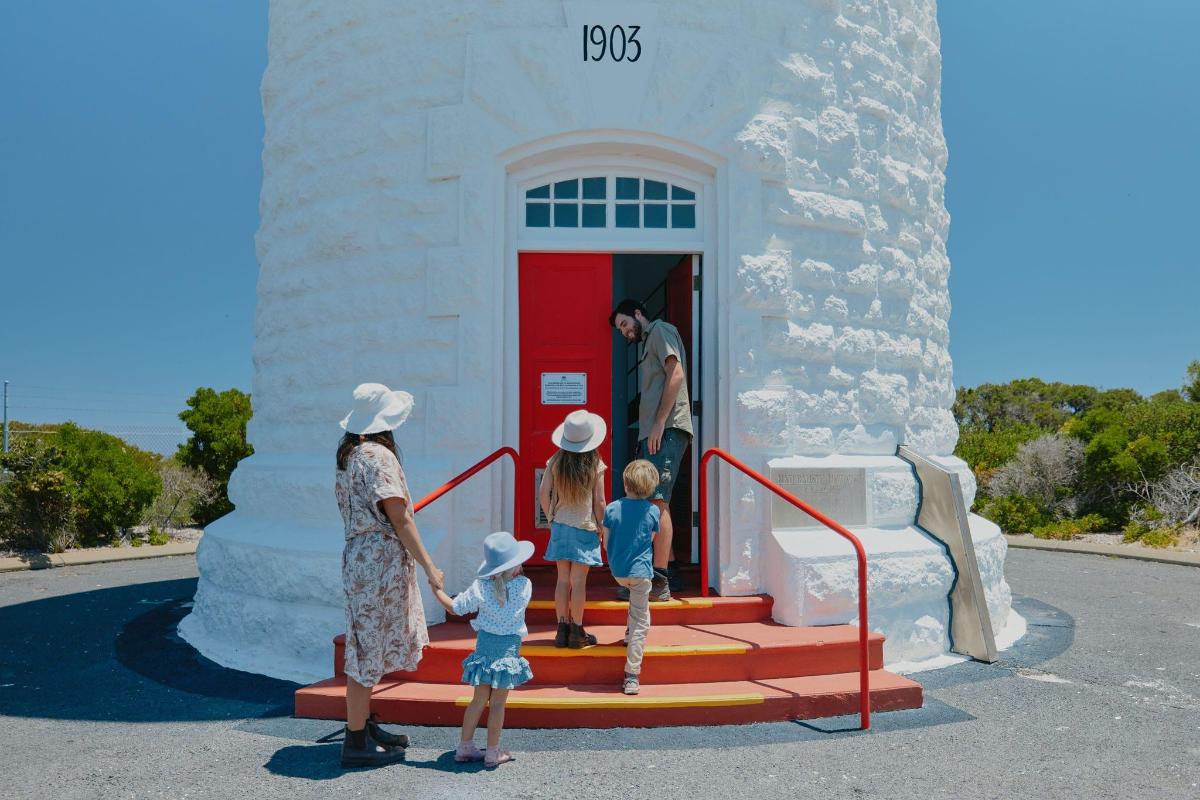 a group of children standing in front of a building
