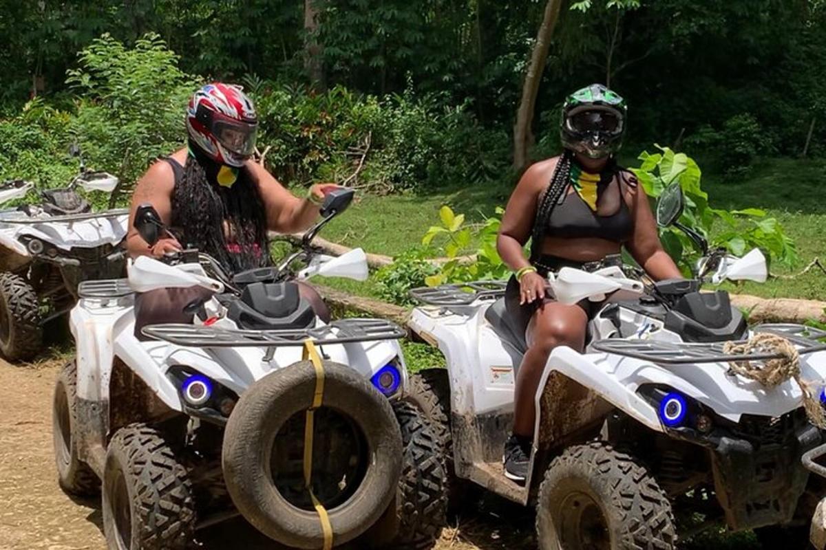 未舗装道路でATVに乗っている2人