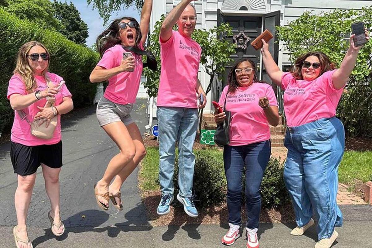 a group of women in pink shirts posing for a picture