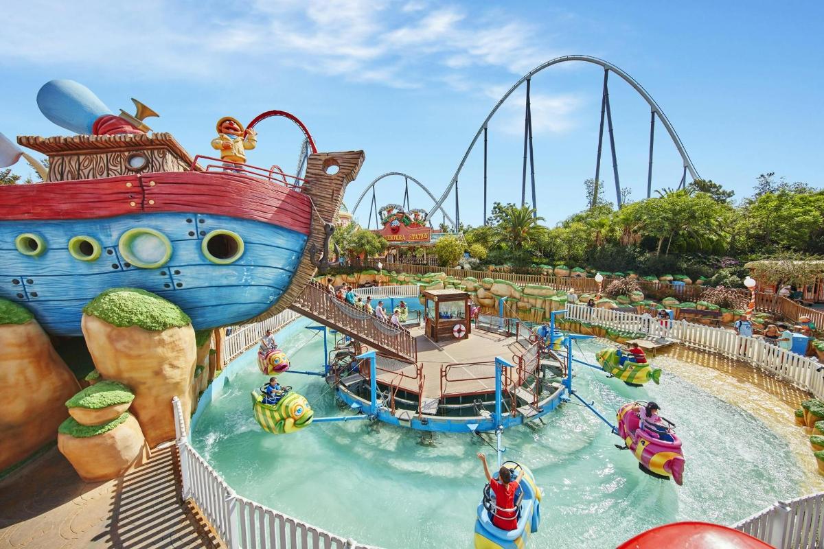 a water park with a pirate ship and a roller coaster