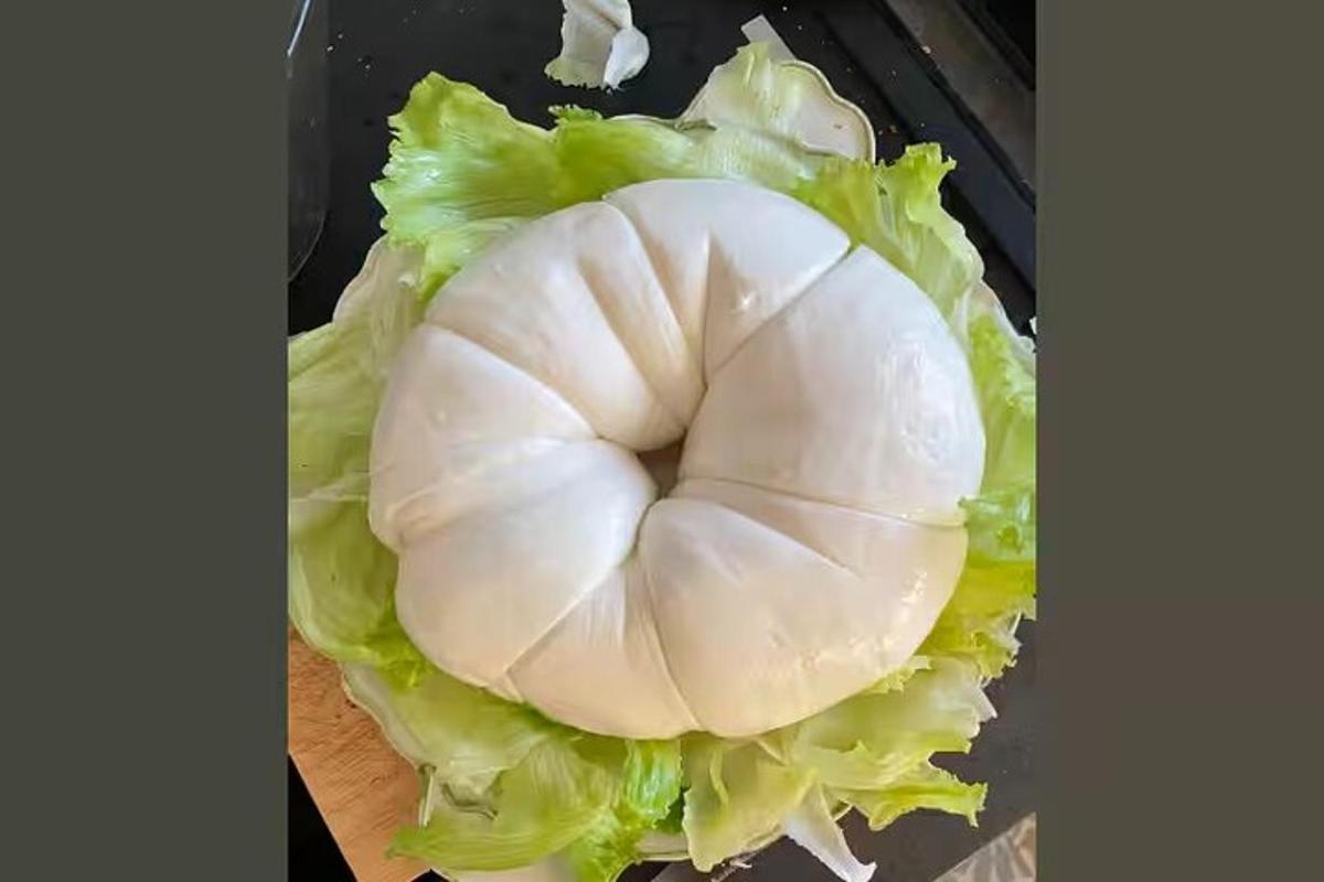 un gall dindi blanc tallat amb enciam sobre una taula de tallar