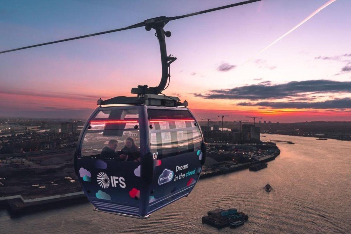 a gondola with people riding on it over a river