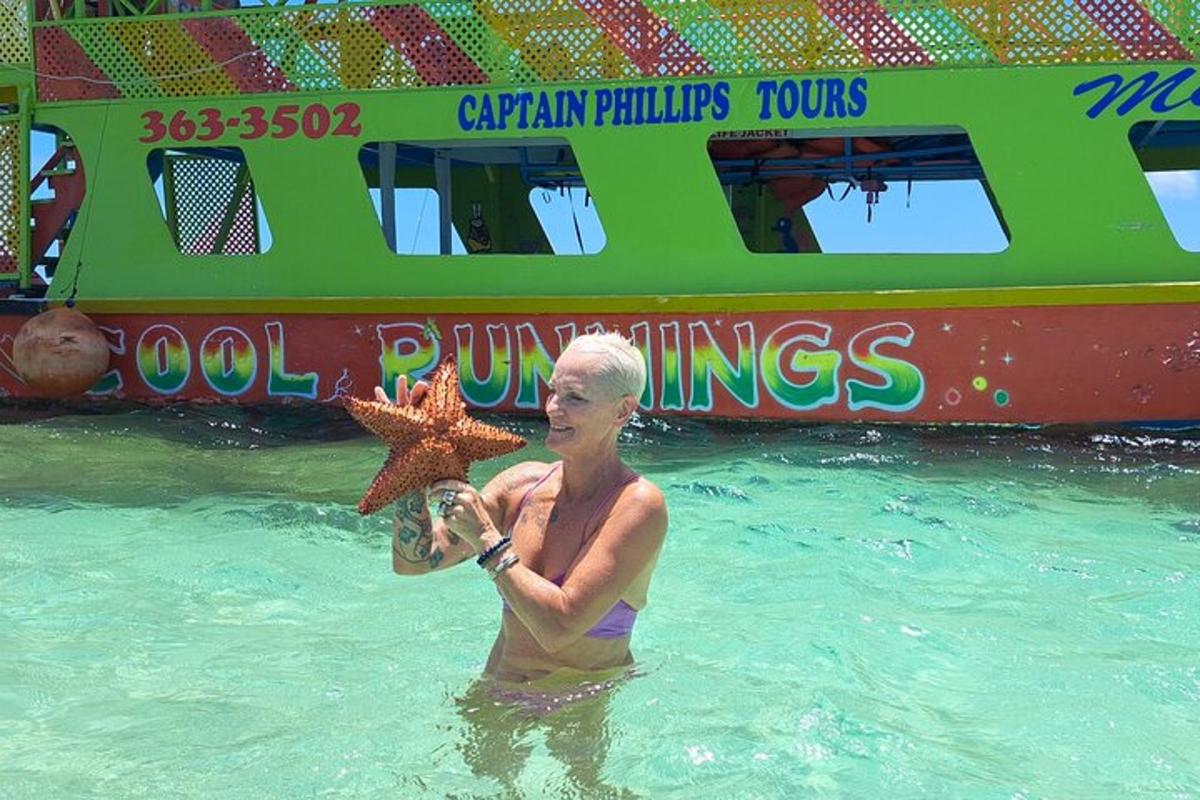 a woman holding a star fish in the water