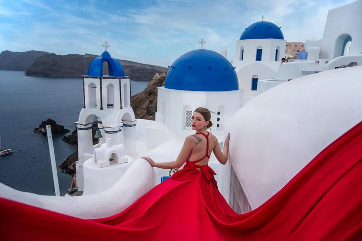 a woman in a red dress is walking down a white building