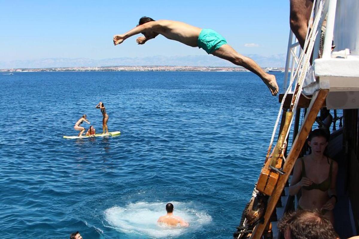 ein Mann springt von einem Boot ins Wasser