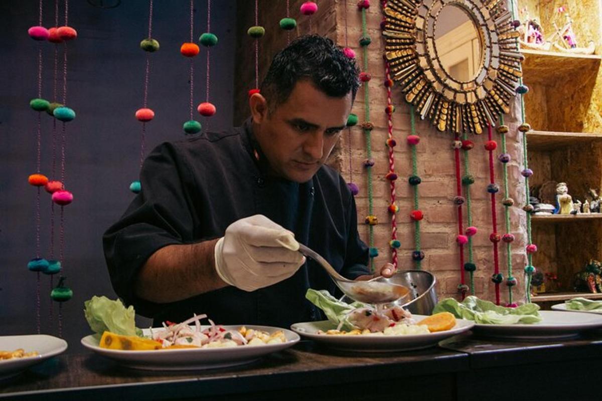 a man is preparing food on a table with plates of food