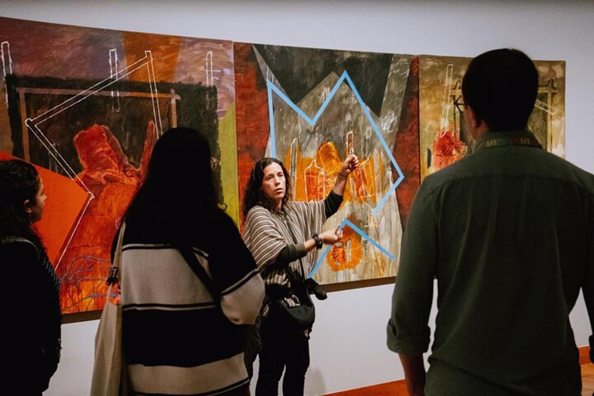 a group of people standing in front of a painting