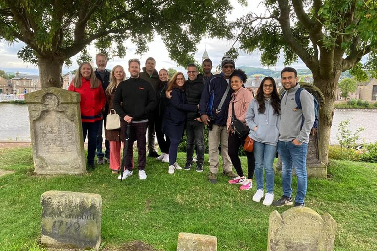 a group of people posing for a picture at a grave