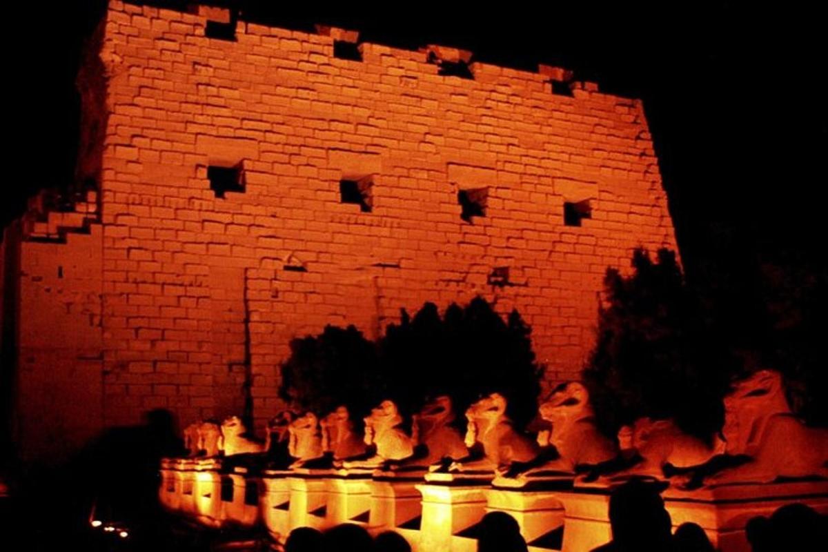 a group of statues in front of a brick building