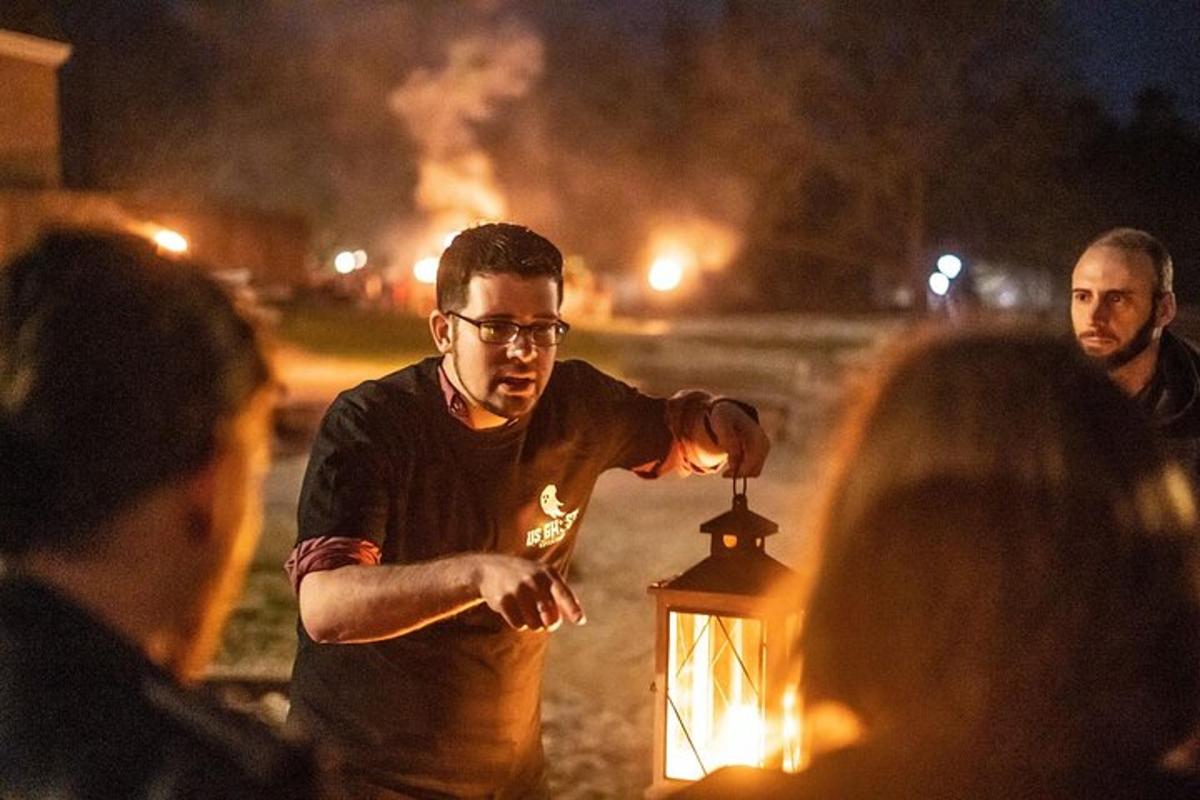 a man is lighting a lantern at night