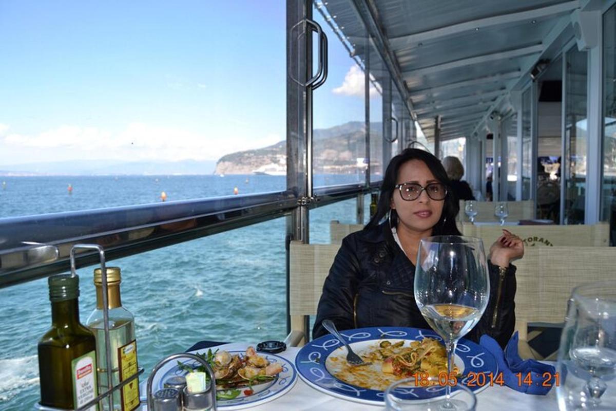 una mujer sentada en una mesa con un plato de comida