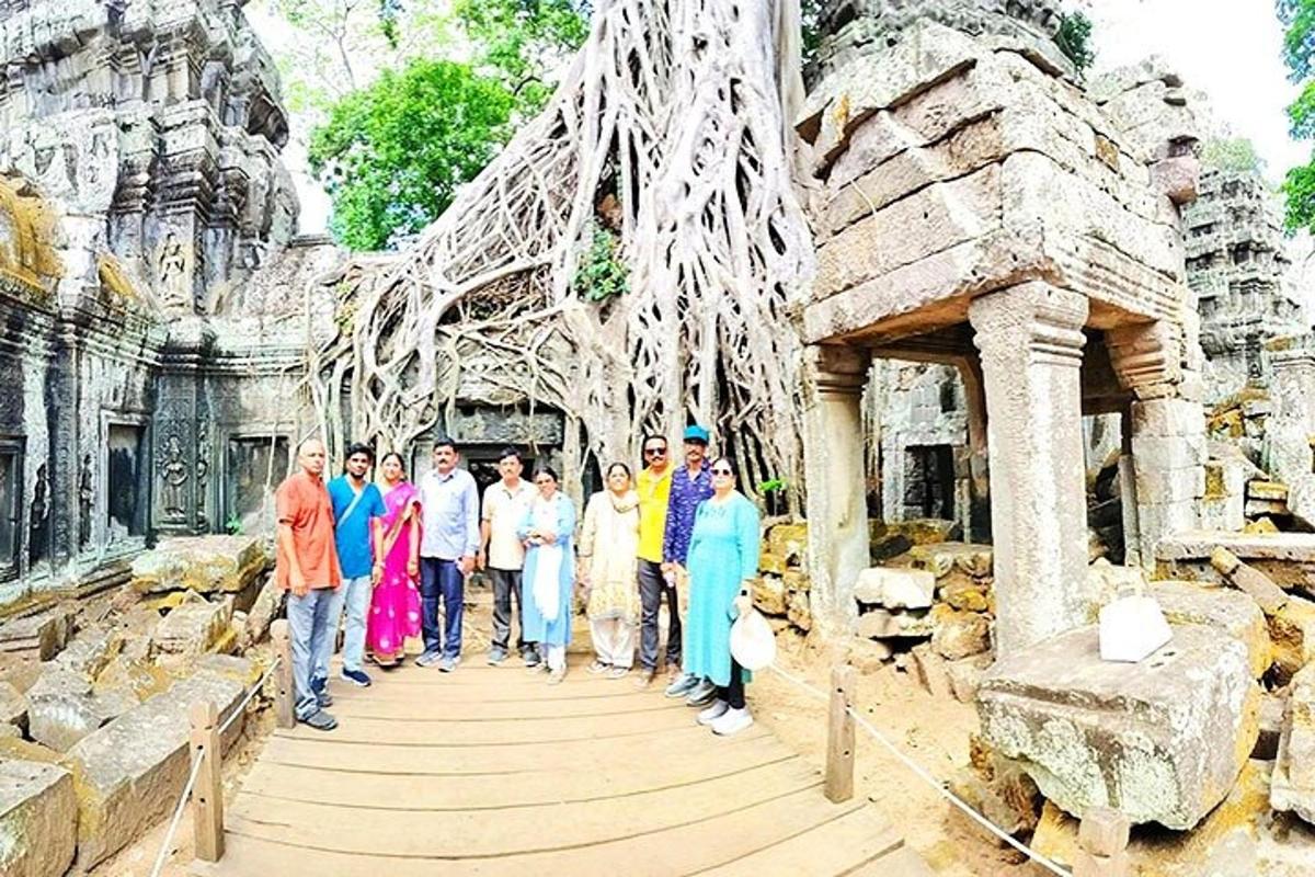a group of people standing on a wooden walkway in a temple
