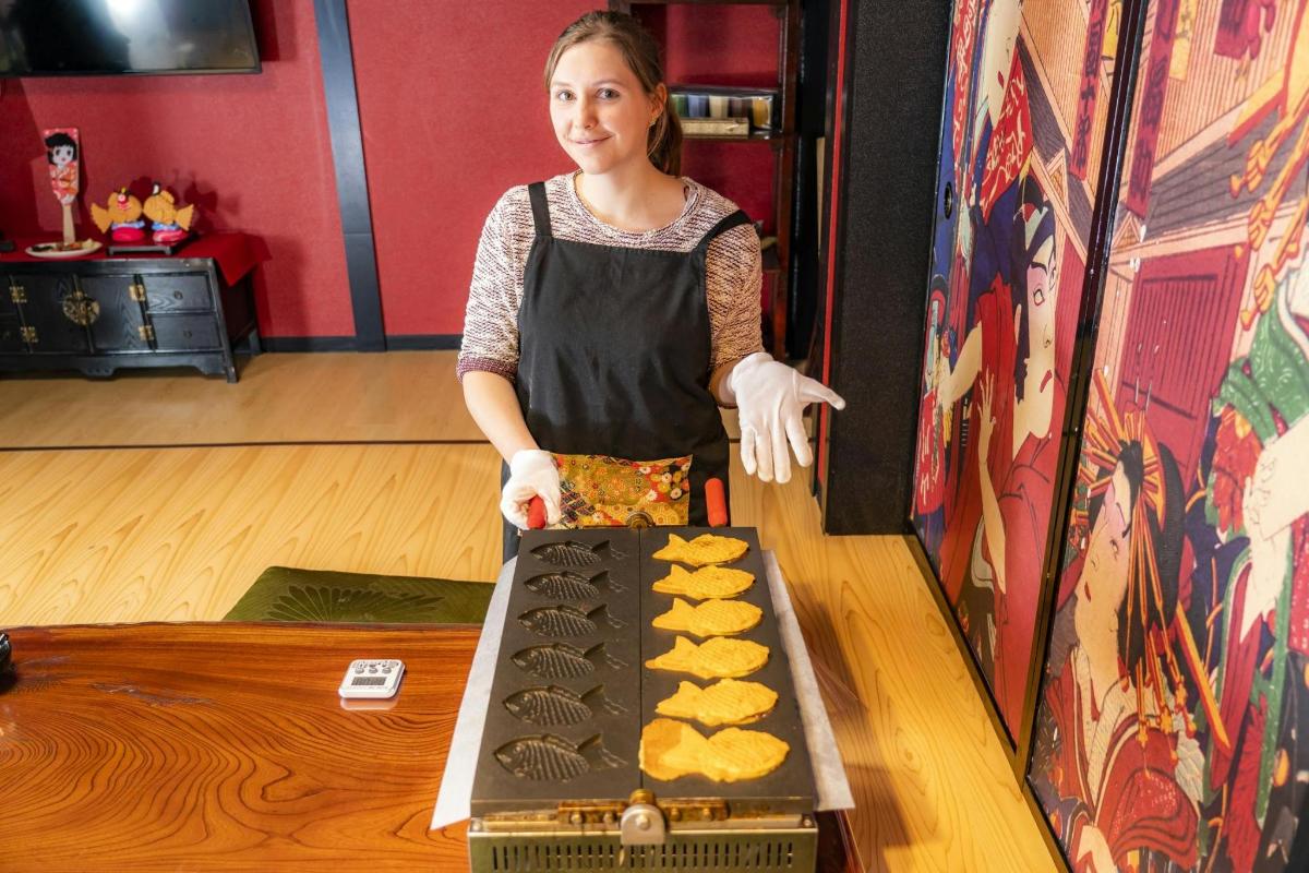 a woman in an apron preparing food on a table