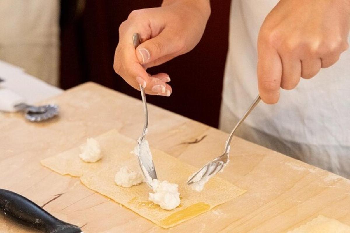 a person eating food with two forks on a cutting board