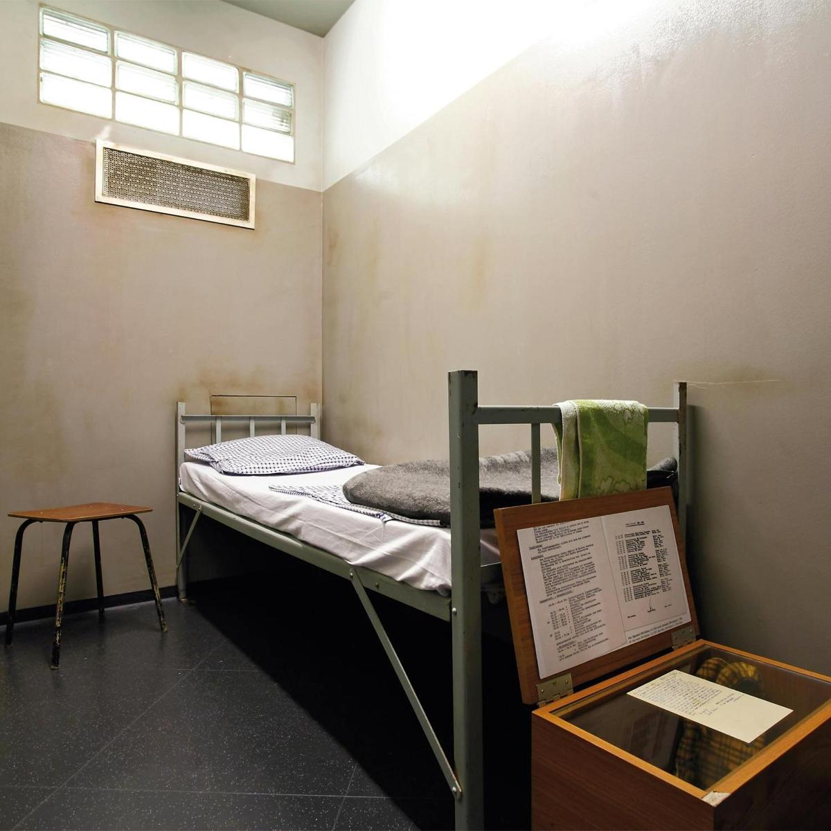 a room with a bunk bed in a room with a window