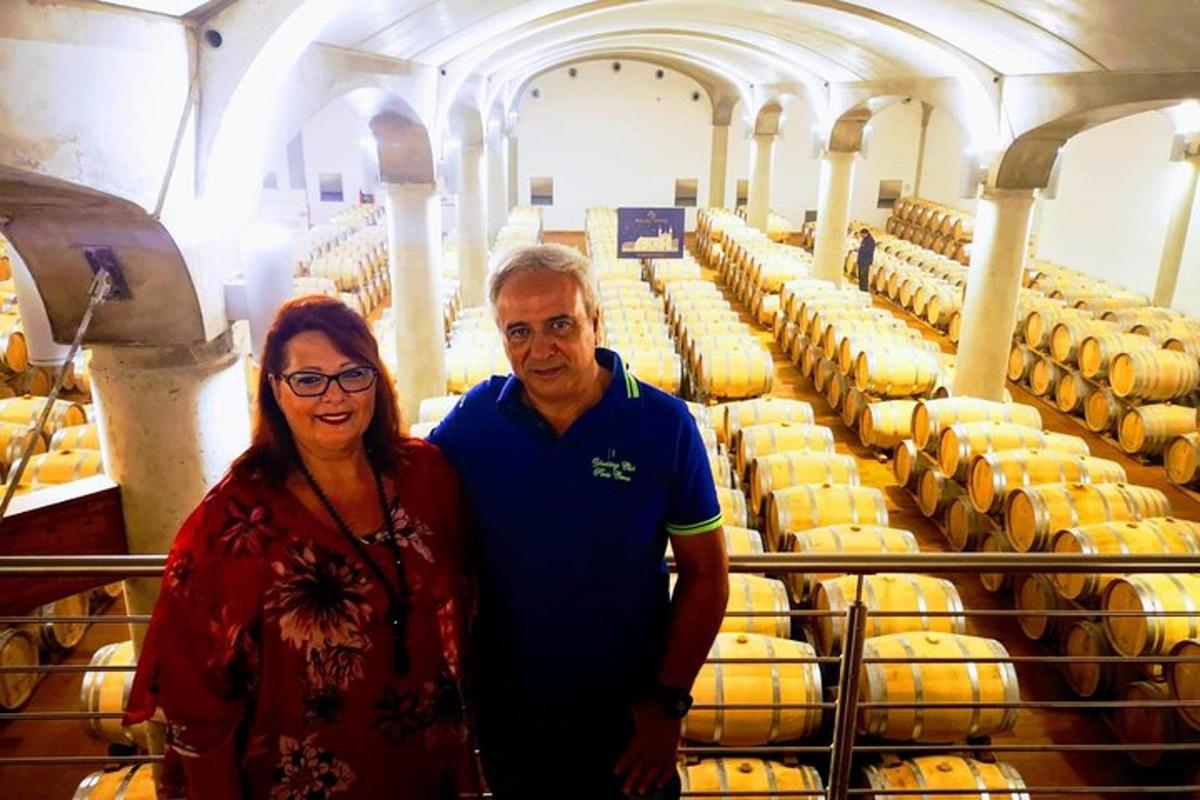 a man and a woman standing in front of a factory
