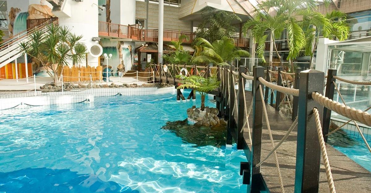 a pool with a water slide in a building