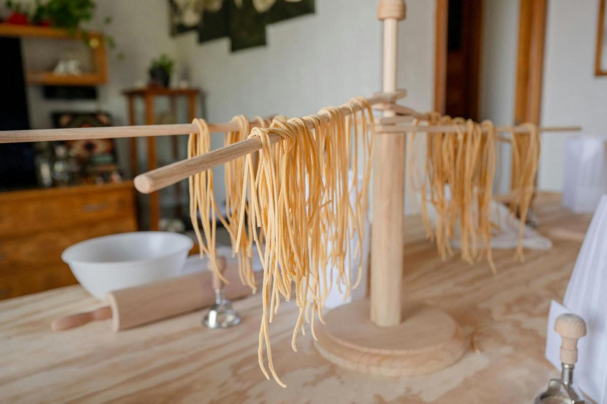 un palo di legno con degli spaghetti sopra un tavolo