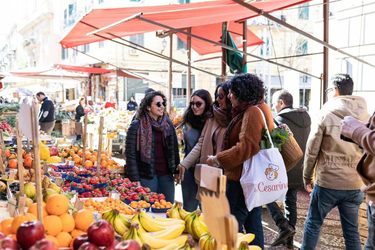 egy csoport nő áll a piacon gyümölcsökkel és zöldségekkel