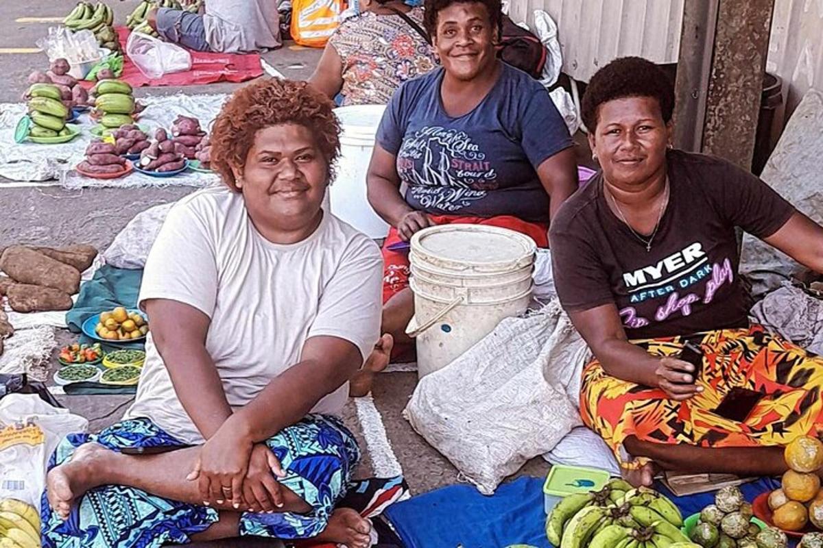 a group of people sitting on the ground with bananas