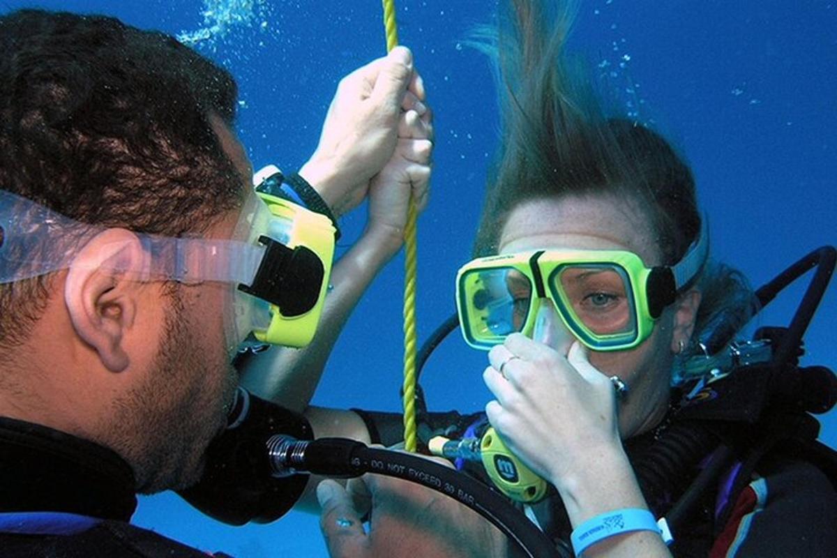 two people with goggles on their faces while underwater