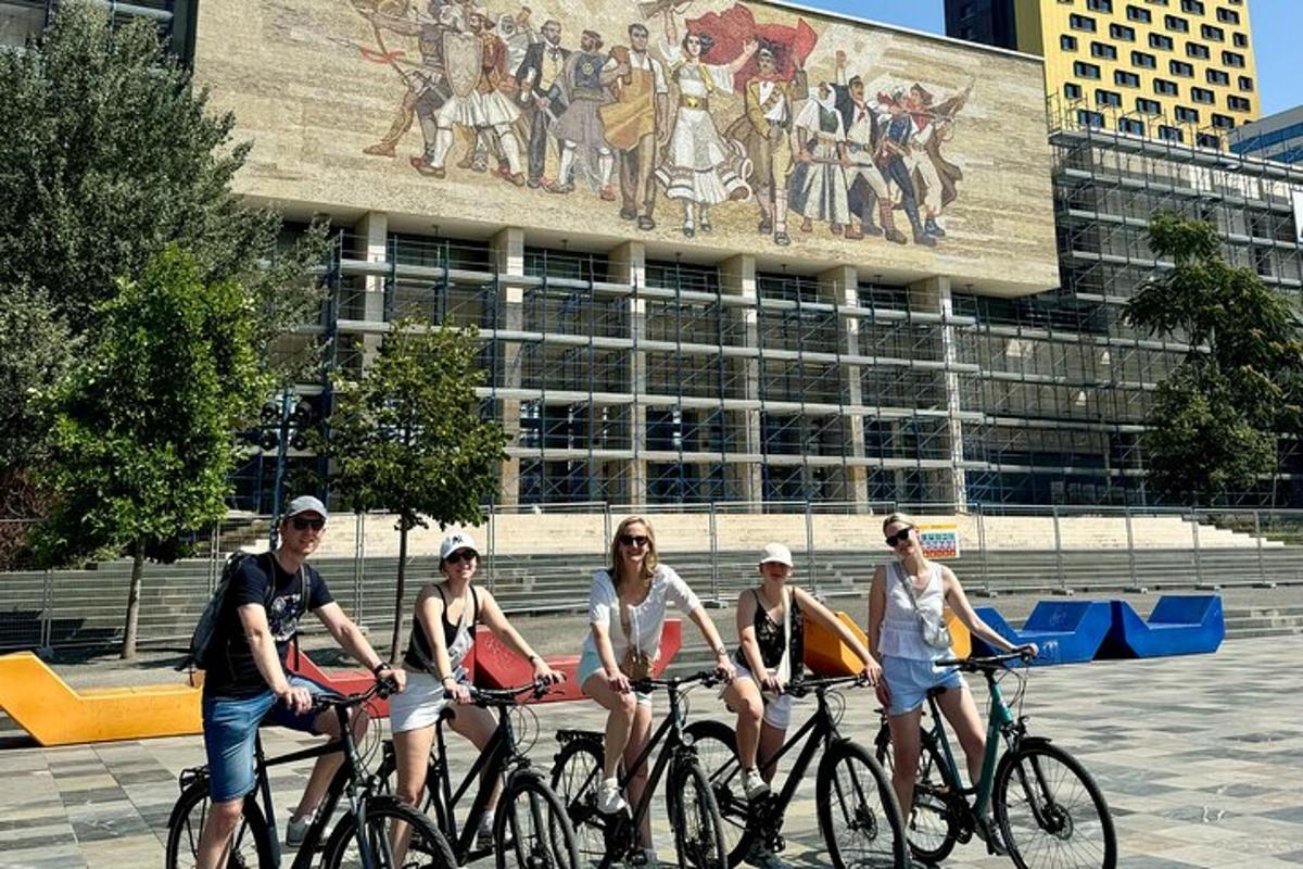 un grup de oameni care merg cu bicicleta în fața unei clădiri