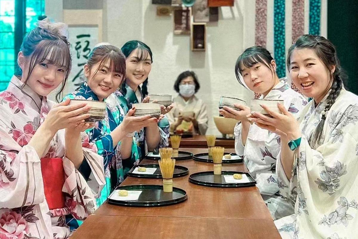 a group of women sitting at a table looking at their cell phones