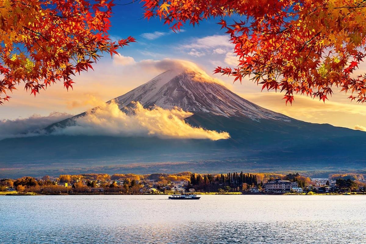 a mountain in the background with a boat in the water