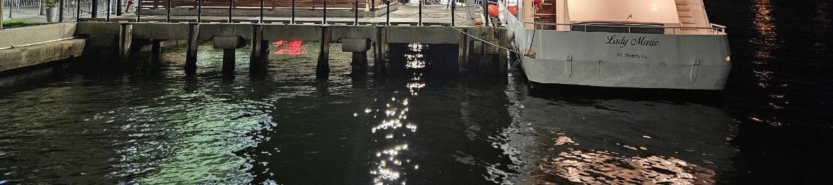 a boat is docked at a dock in the water