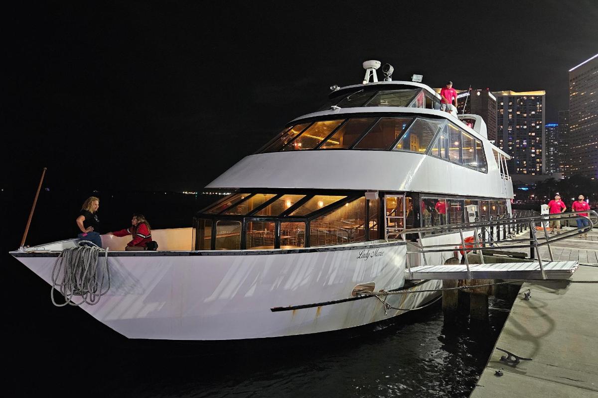 a large white boat in the water at night