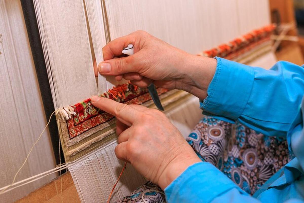a person using a screwdriver to attach a piece of fabric to a mirror