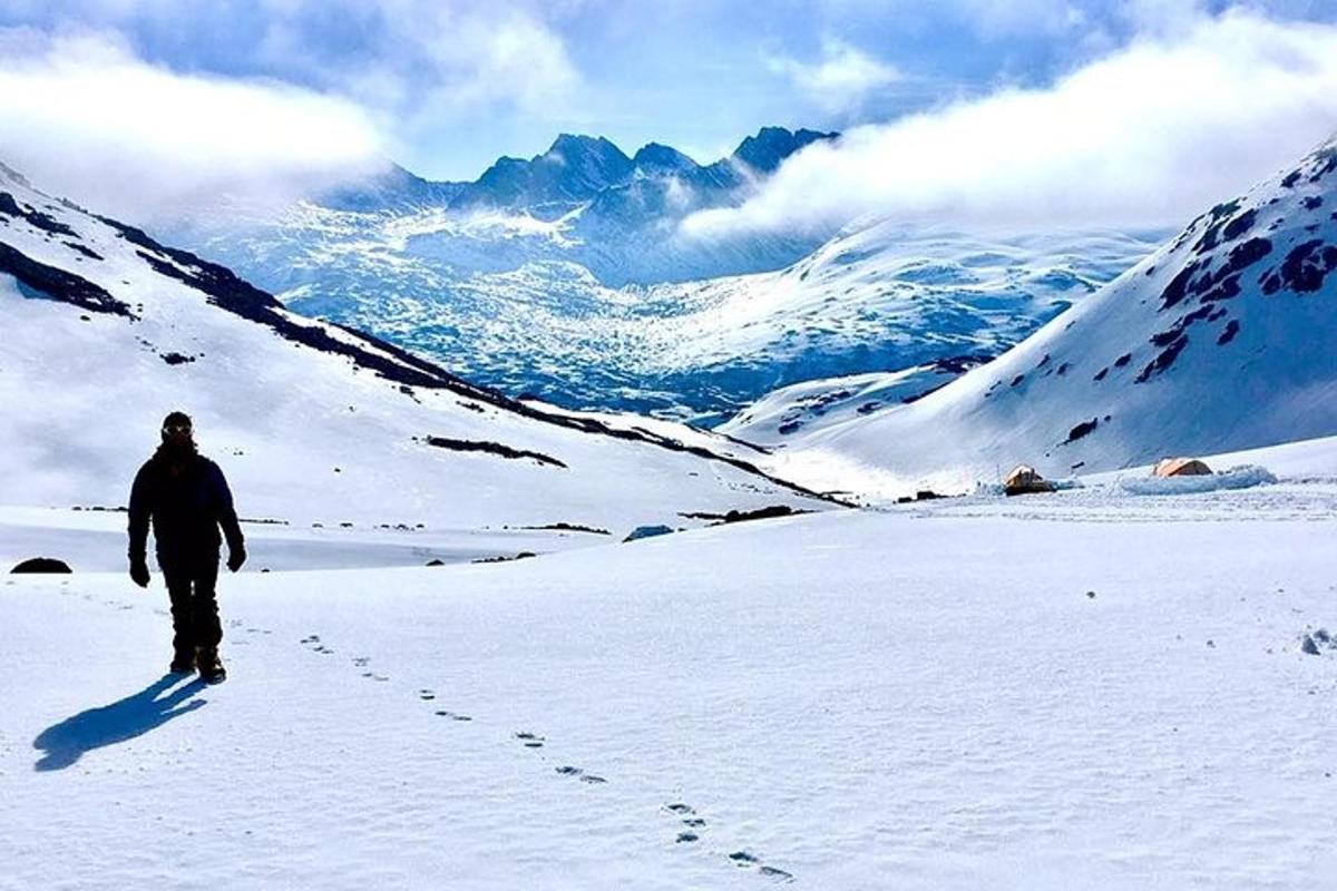 a man walking on a snow covered mountain