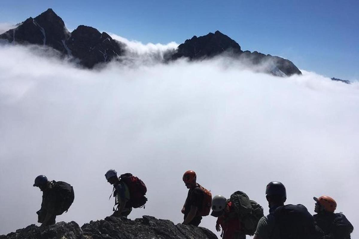 a group of people standing on top of a mountain