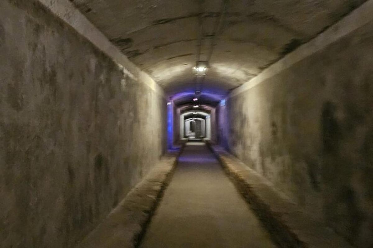 a tunnel with a blue light at the end of it