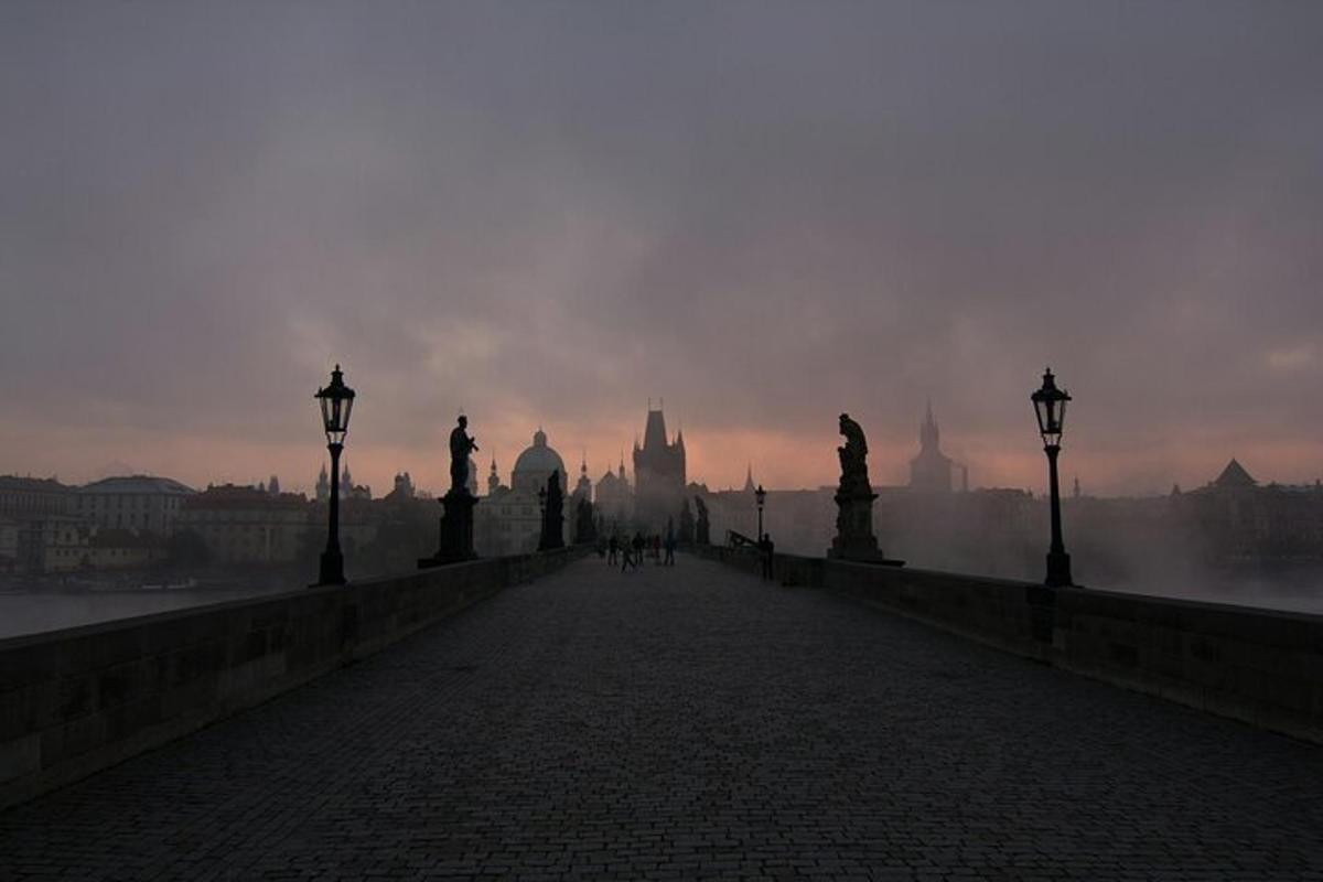a bridge over a river with a city in the background