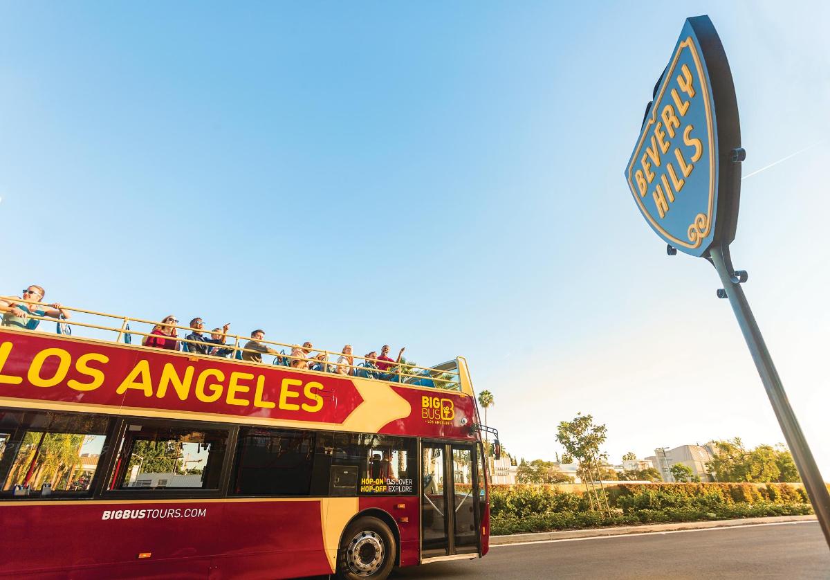 a red double decker bus driving down a street